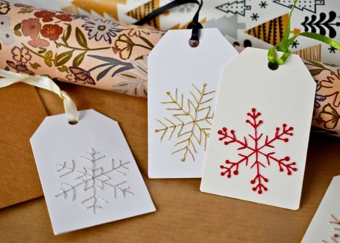 DIY Christmas Gift Tags With Snowflake Embroidery - gold, silver and red snowflakes image