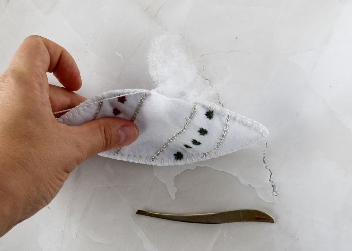 Filling felt ornament with stuffing material image