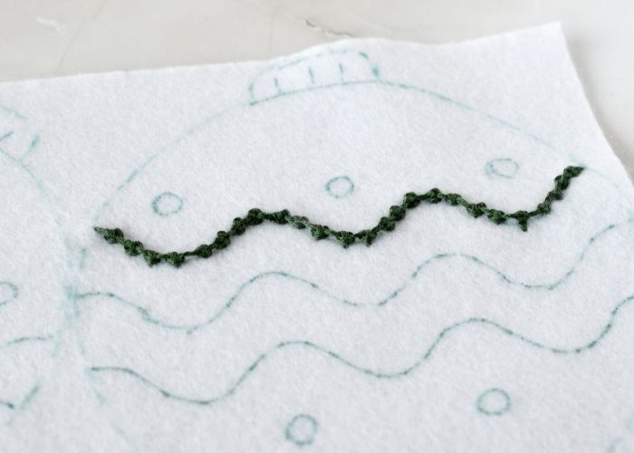 Palestrina stitch embroidery on the Christmas felt ornament with green thread image