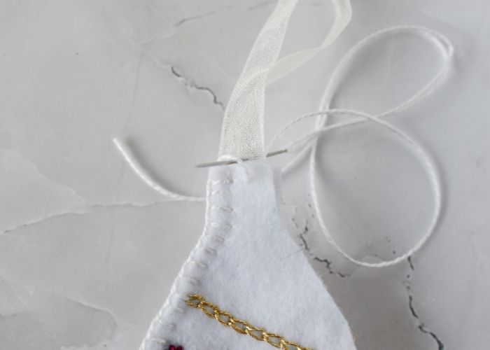 Sewing in the ribbon inside felt ornament image