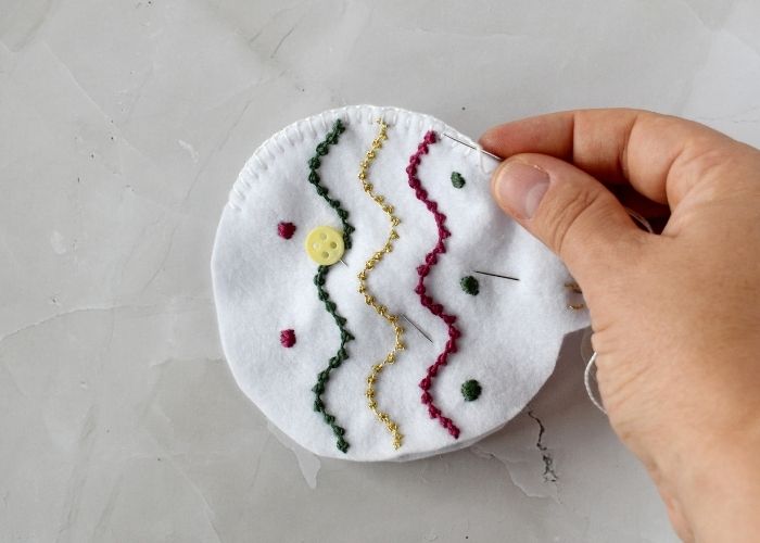 Sewing with Blanket stitch white felt ornament with embroidery image