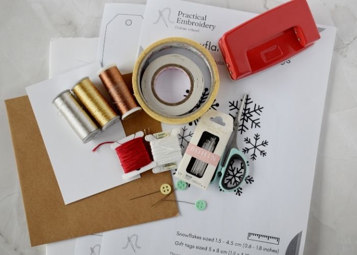 Tools and materials to make gift tags with snowflakes image