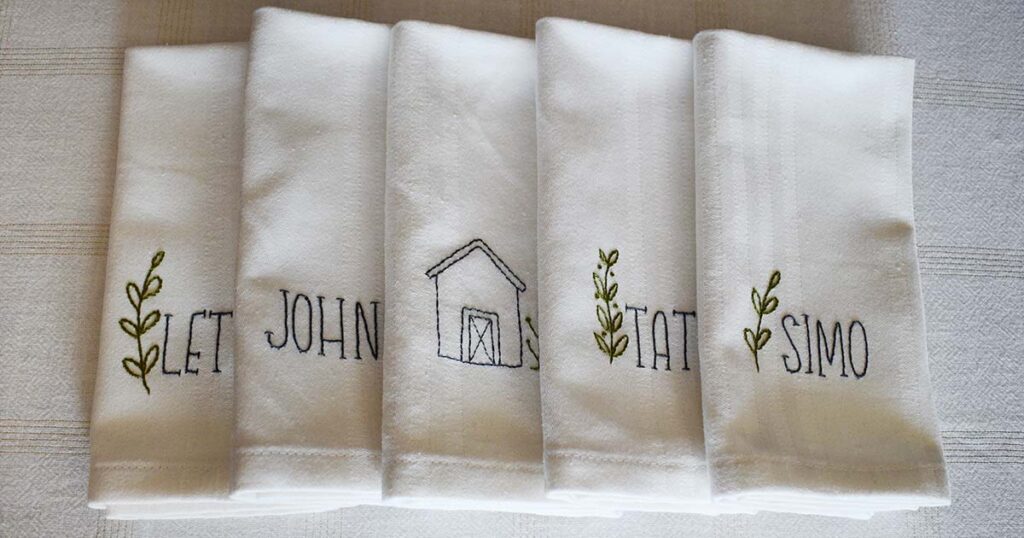 Monogrammed fabric napkins with names and plants - image