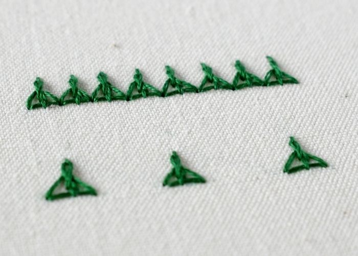 Indian Edging Stitch embroidery sampler with green floss image