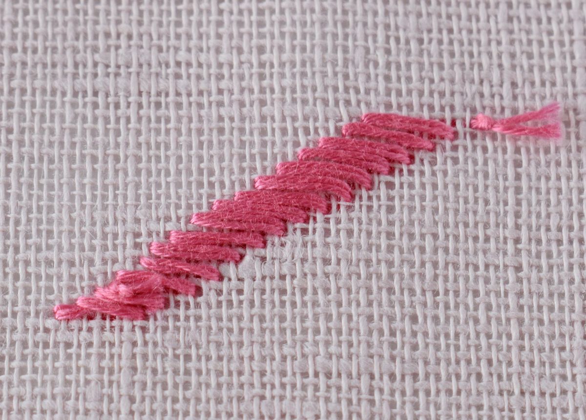 Japanese Stitch embroidery sampler with pink thread on linen back side image