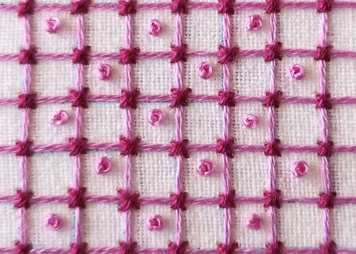 Lattice stitch hand embroidery with pink threads